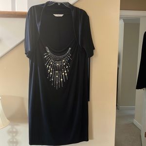 Black slinky knit dress with silver and gold studs across front.